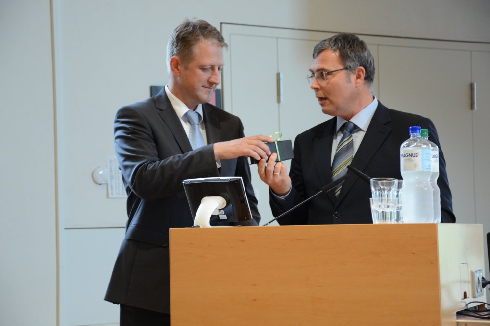 Vizepräsident Prof. Dr. Thomas Severin überreicht Festredner Michael Otten von der WiREG ein Gastgeschenk