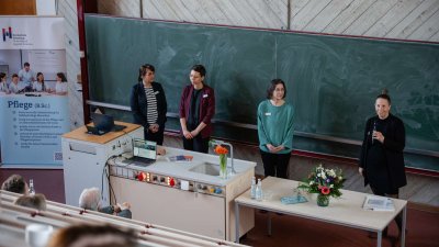 Vier Frauen vor einer grünen tafel