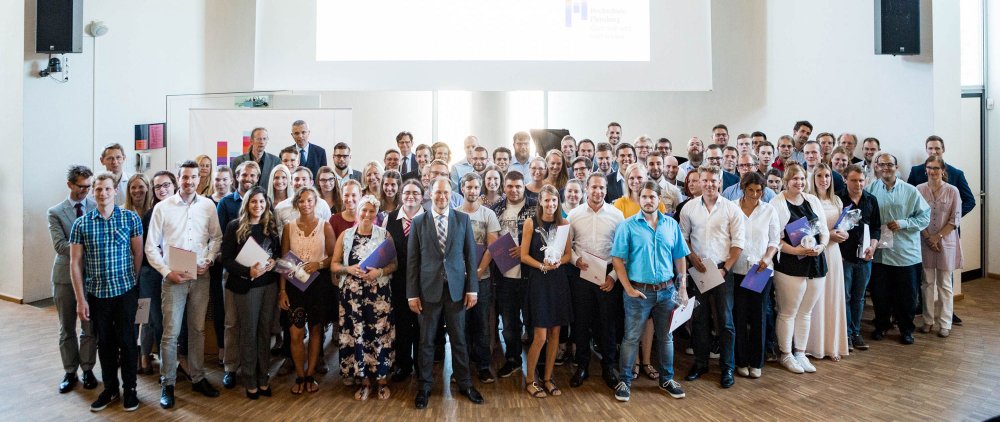 Gruppenbild aller Absolventen und Absolventinnen mit Lehrenden, Präsident und Leiterin des Studierendenservice.