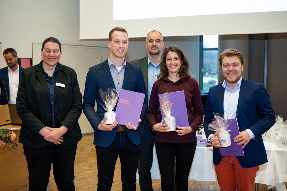 Eine kleine Gruppe Absolventinnen und Absolventen mit der Vizepräsidentin und dem Prodekan des Fachbereichs 1.