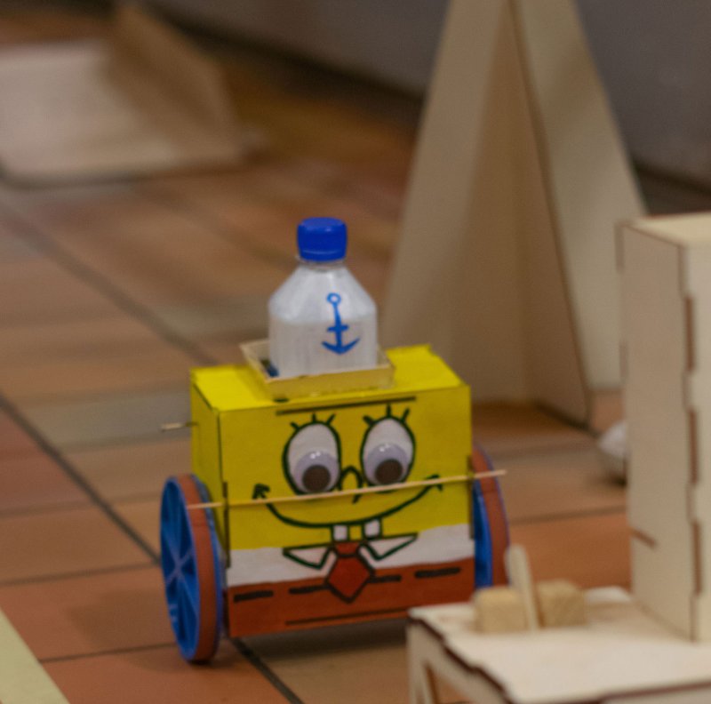 Kleiner Roboter, der aussieht wie Spongebob auf einer selbstgebauten Rennstrecke.
