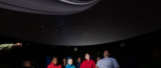 Schulkasse im Planetarium, im oberen Bildbereich ist die Projektion zu erkennen.